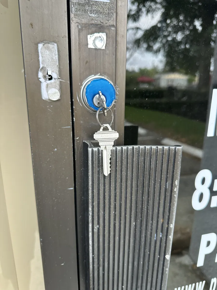 New mortise cylinder with key in an aluminum storefront door in Hollywood, FL